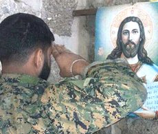 Un combattente di Hezbollah e l'immagine di Cristo